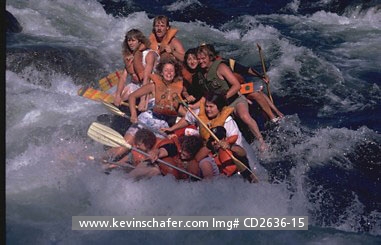 USA, CALIFORNIA: People river rafting in California, going through white water.