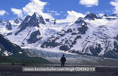USA, ALASKA, PEOPLE: Glacier Bay National Park,  hiker viewing Walker Glacier from a distance.