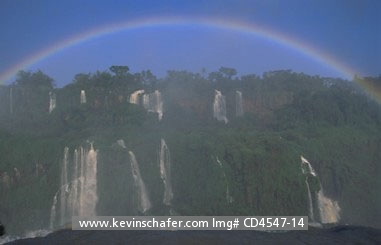 BRAZIL, PARANA: Brazil, Iguacu Falls, Iguacu National Park, rainbow reaching above falls viewed from Brazilian side, September.