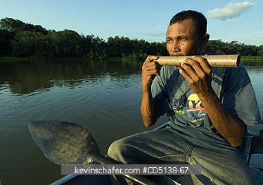 BRAZIL: Guide on boat, calling to Jaguars, Piquiri River, Pantanal, Mato Grosso, Brazil.