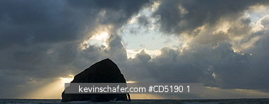 OREGON, USA: Haystack Rock and arch at sunset, Cape Kiwanda, Oregon Coast, Pacific Ocean