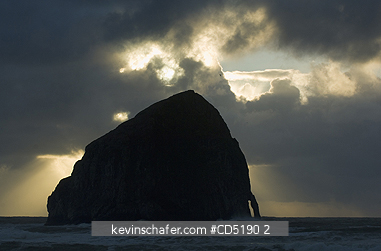 OREGON, USA: Haystack Rock and arch at sunset, Cape Kiwanda, Oregon Coast, Pacific Ocean
