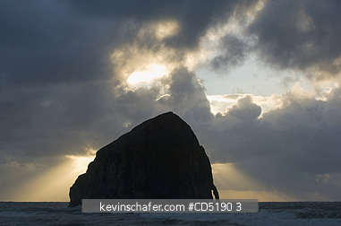 OREGON, USA: Haystack Rock and arch at sunset, Cape Kiwanda, Oregon Coast
