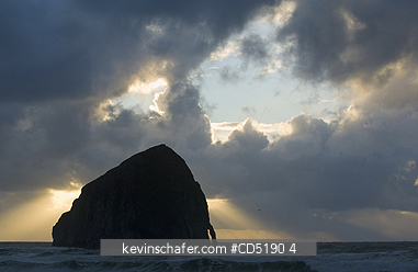 OREGON, USA: Haystack Rock and arch at sunset, Cape Kiwanda, Oregon Coast, Pacific Ocean