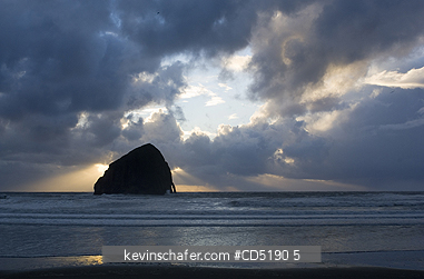 OREGON, USA: Haystack Rock and arch at sunset, Cape Kiwanda, Oregon Coast, Pacific Ocean