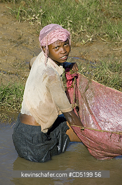 MADAGASCAR: Fishing in rice paddies, young girl, Madagascar