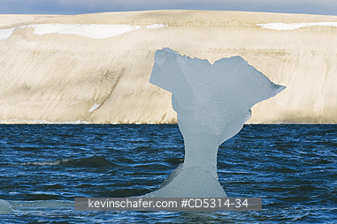ICEBERGS: Small iceberg and barren landscape, Palanderbukta, Nordaustlandet, Svalbard