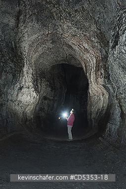 MT ST. HELENS, WASHINGTON: Hiker in Ape Cave, lava tube, Mt. St. Helens National Monument, Washington
