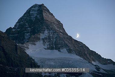 CANADA, BRITISH COLUMBIA: Moonset over Mt. Assiniboine from Magog Lake, Mt. Assiniboine Provincial Park, British Columbia, Canada SEPTEMBER