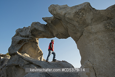 IDAHO, PEOPLE: Man in Window Arch, sunrise, City of Rocks National Reserve, Southern Idaho