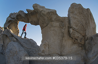 IDAHO, PEOPLE: Man in Window Arch, sunrise, City of Rocks National Reserve, Southern Idaho