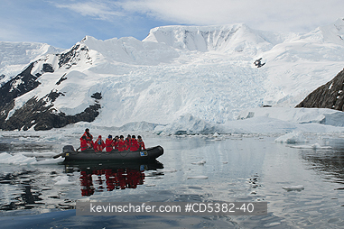 ANTARCTICA, PEOPLE: Zodiac below glaciers and mountains, Neko Harbor, Antarctic Peninsula, Antarctica