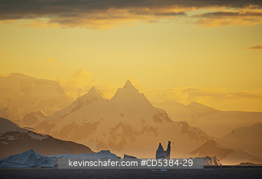 ANTARCTICA, SCENIC: Mountains and Icebergs at dusk, ca 11 PM, just south of Lemaire Channel, Antarctica
