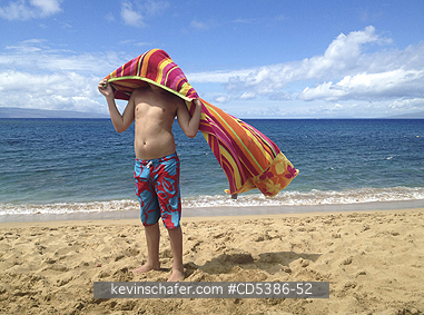 BOY:  Boy, aged 12, playing with beach towel, Maui, Hawaii (MOBILE PHONE)