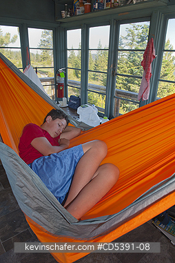 OREGON, PEOPLE: Theo Braibish, aged 12, Resting in hammock, Five Mile Butte Lookout tower, Mt. Hood National Forest, Oregon