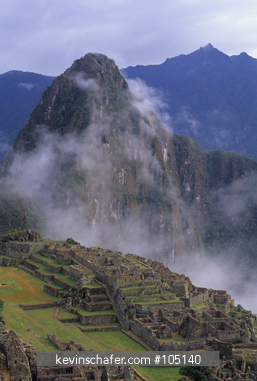 PERU, MACHU PICCHU: Ina ruins, misty morning above Urubamba Valley.