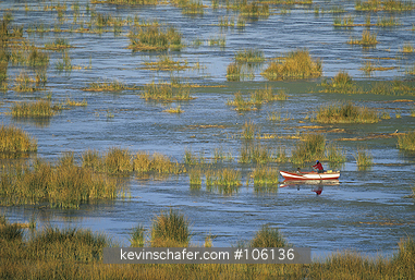 PERU, LAKE TITICACA: Lake Titicaca, Andes, 3,810 meters, boat navigates tortora reed beds.