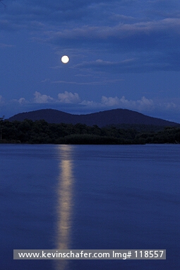 RUSSIA, FAR EAST: Ussuriland, Russian far East, Bikin River, view of reflected full moon as it rises over river.