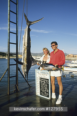 MEXICO, BAJA CALIFORNIA, FISHING: Mexico, Baja California, Cabo San Lucas, fisherman with catch, major Pacific Marlin fishing port.