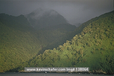 COSTA RICA: Costa Rica, Cocos Island National Park, Sunset on forest-lined cliffs.