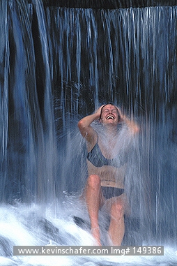 COSTA RICA: Costa Rica, Tabacon Hot Springs, Arenal area, Woman in hot waterfall.