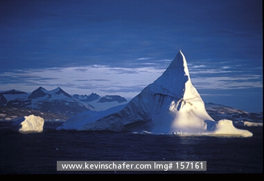 GREENLAND, SCENIC: East Coast, view of towering iceberg at dawn.