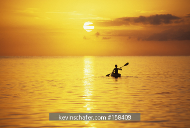 BELIZE: Glovers Reef Atoll, Southwest Cay, kayaker at sunset.