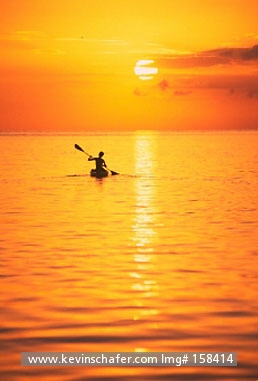 BELIZE, COASTAL: Glover\\\'s Reef Atoll, SW Cay kayaker at sunset. Caribbean Sea