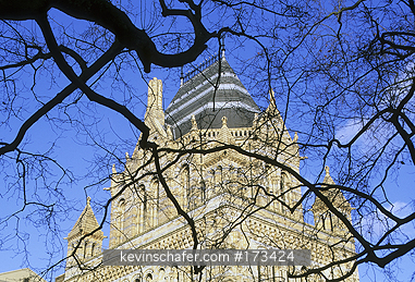 UNITED KINGDOM: United Kingdom, Britain, London, South Kensington, Museum of Natural history seen through tree branches.
