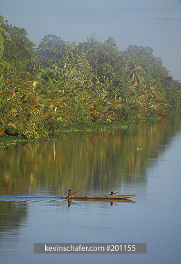 PAPUA NEW GUINEA, PEOPLE: Papua New Guinea, Sepik River, Natives cross river in dugout canoe.