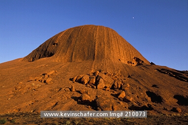 AUSTRALIA: Australia, Uluru, Ayers Rock, Sandstone massif, Sunrise at base of rock.