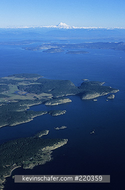 WASHINGTON, USA: Mt. Baker rises above San Juan Islands, Lopez Island, aerial.