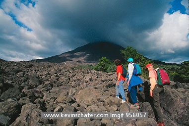 COSTA RICA: Costa Rica, Arenal Volcano, Hikers on lava flow.  Costa Rica is a prime destination for ecotourism.