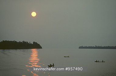 BRAZIL, PEOPLE: Dugout canoe at sunrise, traversing the Amazon River.