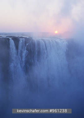 AFRICA, ZIMBABWE: Dawn through mist over Victoria Falls,  Zambezi River .