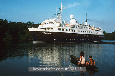 BRAZIL, PEOPLE: Cruise ship shares passage through Amazon River with dugout canoe.