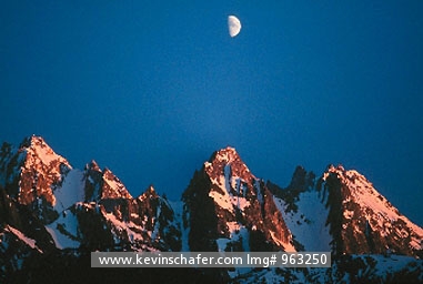 USA, ALASKA: Moon over Cathedral Peaks near Haines, Alaska.
