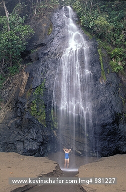 COSTA RICA: Costa Rica, Corcovado National Park, Hiker at waterfall.