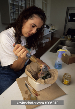 PUERTO RICO, PEOPLE: Woman feeding young Parrot, USFWS Aviary